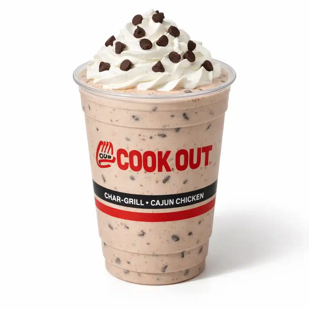 Cookout Chocolate Chip Milkshake in a branded plastic cup with visible chocolate chips and whipped cream on a pure white background