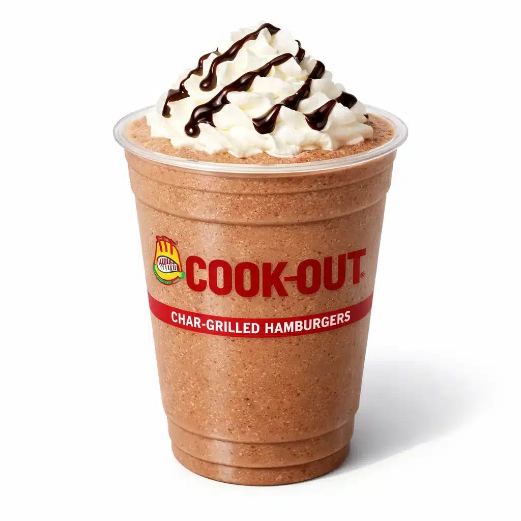 Cookout Chocolate Malt Milkshake in a branded plastic cup with whipped cream and chocolate drizzle on a pure white background